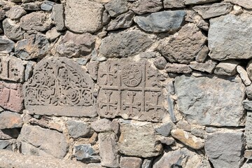 Armenia, Geghard, September 2021. The wall of the monastery with Christian ornament.
