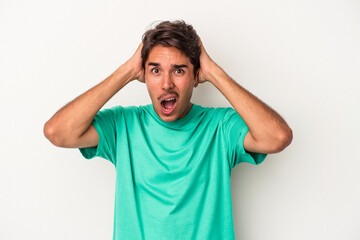 Fototapeta premium Young mixed race man isolated on white background screaming, very excited, passionate, satisfied with something.