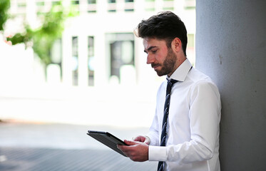 Fototapeta premium Young manager using a digital tablet outdoor