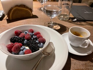 berries in a bowl and cup of coffee