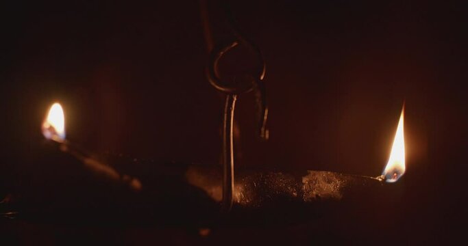 Nighttime outdoor antique burning rushlight.
