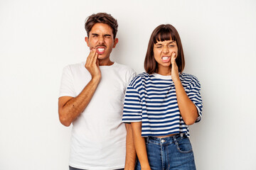 Young mixed race couple isolated on white background having a strong teeth pain, molar ache.