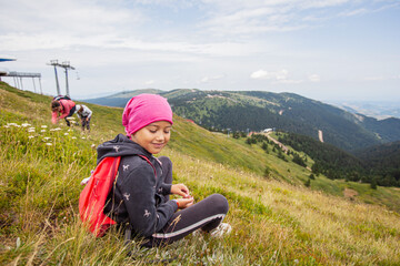 Naklejka na ściany i meble Little girls hiker relaxing on the peak, beautiful view on nature landscape