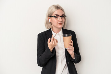 Young caucasian business woman holding take away coffee isolated on white background pointing with finger at you as if inviting come closer.