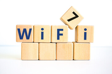 WiFi 7 symbol. The concept word WiFi 7 on wooden cubes. Beautiful white table, white background, copy space. Business, technology and WiFi 7 or WiFi7 concept.