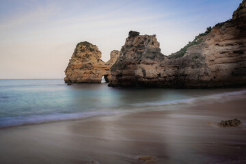 Fototapeta na wymiar Rocks at Praia do Camilo Beach - Long Exposure shot - Lagos, Algarve, Portugal