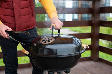 Man cooking a meal on the grill outdoors close up