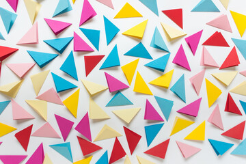 Abstract background with randomly arranged colorful folded triangles on white background