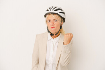 Young business Russian woman holding bike helmet isolated on white background showing fist to camera, aggressive facial expression.
