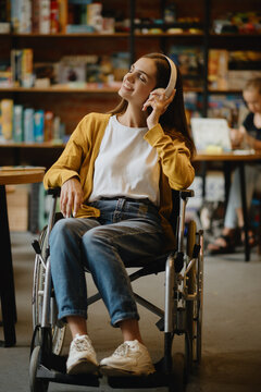 Disabled student listen to music in headphones