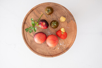 organic tomatoes on a wooden plate