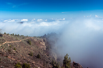 Mountainous landscape with fog over the mountain.