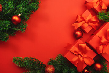 Merry Christmas and Happy New Year red background with boxes, ribbons, bows, fir branches and holiday decor. Gift wrapping. Preparation for holidays. Top view