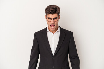 Young business caucasian man isolated on white background screaming very angry and aggressive.