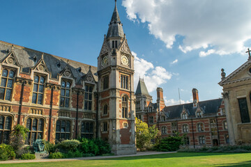 View of historical bricked Christ's College building attached to a medieval style clock tower in...