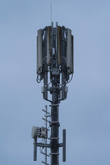 A Radio mast in an with a blue sky in the background