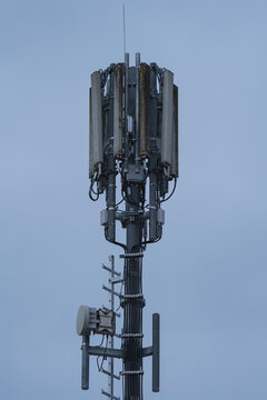 A Radio mast in an with a blue sky in the background