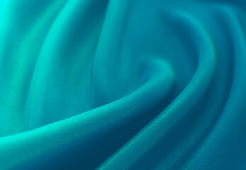 A piece of turquoise,aquamarine, blue. cloth. Fabric texture for background and design works of art, beautiful wrinkled pattern of silk or linen. A crumpled piece of cloth