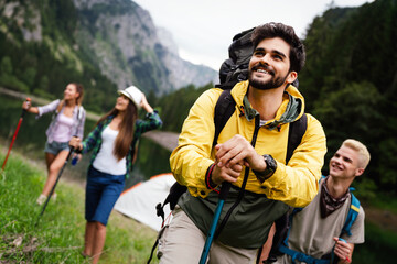 Naklejka premium Group of fit healthy friends trekking in the mountains