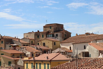 Elba, Italy – September 02, 2021: beautiful places from Elba Island. Aerial  view to the island. Little famous villages near the beaches. Summer tourist places. Clouds and blue sky in the background.