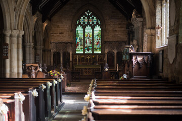 Wakefield, West Yorkshire, United Kingdom - October 03 2021: St Peter the Apostle Church, Kirkthorpe Lane. The pews in front of the altar and the church interior