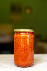 Close-up of ajvar in a glass jar. Traditional Serbian cuisine