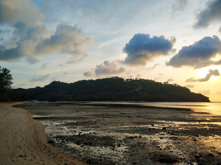 Evening sunset on the beach of a tropical island by the ocean