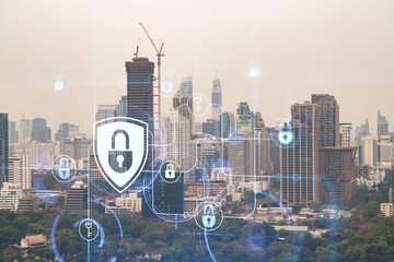 Padlock icon hologram over panorama city view of Bangkok to protect business in Southeast Asia. The concept of information security shields. Double exposure.