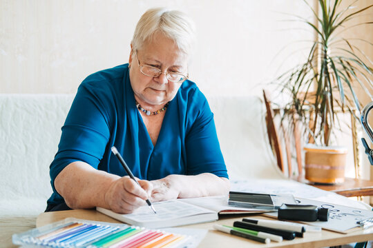 Hobby Ideas for Older People. Retirement Hobbies, Pastimes for Seniors. Activities for Seniors with Limited Mobility. Mature, elderly woman practices spelling words, online hand lettering class