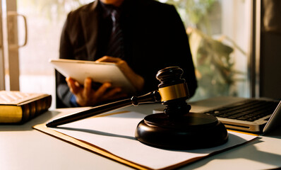 Business and lawyers discussing contract papers with brass scale on desk in office. Law, legal services, advice, justice and law concept