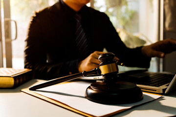 Business and lawyers discussing contract papers with brass scale on desk in office. Law, legal services, advice, justice and law concept