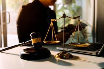 justice and law concept.Male judge in a courtroom on wooden table and Counselor or Male lawyer...