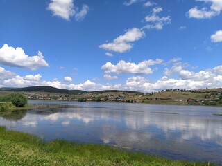 reflection of clouds in the waters of a clear lake