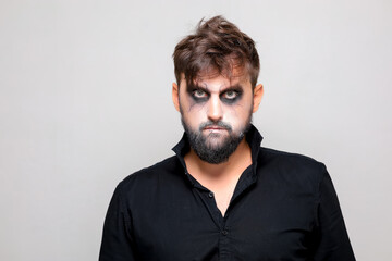 bearded men with makeup for Halloween looks at the camera