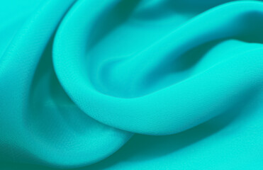 A piece of turquoise,aquamarine, blue. cloth. Fabric texture for background and design works of...