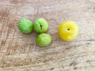 a ripe and some dried plum fruits on the table