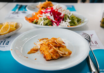 Mediterranean food concept. Fried fish on the white plate.