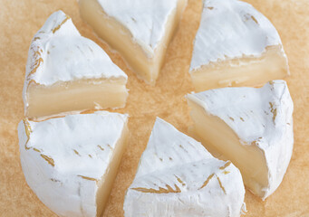 Camembert on a white background. Camembert cheese close-up on a white background.