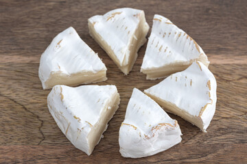 Camembert on a wooden board. Camembert cheese on a board close-up.
