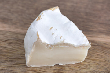 Camembert on a wooden board. Camembert cheese on a board close-up.