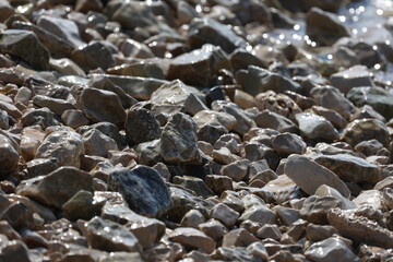 The sea wave washes the rocky beach