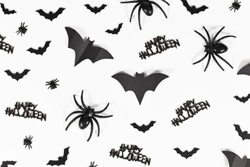 Black Halloween bats, spiders, flies and Happy Halloween text on white background
