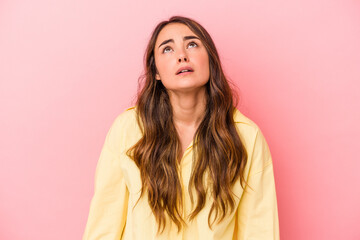 Fototapeta premium Young caucasian woman isolated on pink background shouting very angry, rage concept, frustrated.