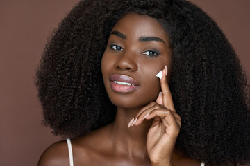 Beautiful happy African American young woman with afro hair and perfect smooth skin complexion...