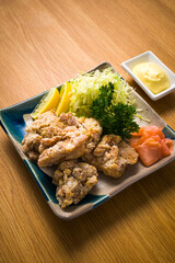 Japanese food, Tori Karaage, fried chicken with mayonnaise sauce over wooden table