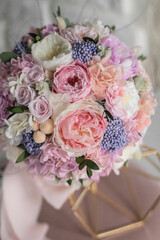 Stylish bridal bouquet of preserved flowers. Wedding bouquet of white and pink roses. Close up of wedding bouquet.