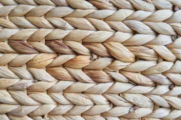 Raffia handmade waving background. Cattail weave knitted fabric with a textured surface