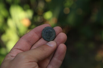 Ancient Roman coin in hand