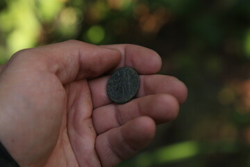 Ancient Roman coin in hand