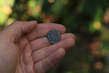 Ancient Roman coin in hand